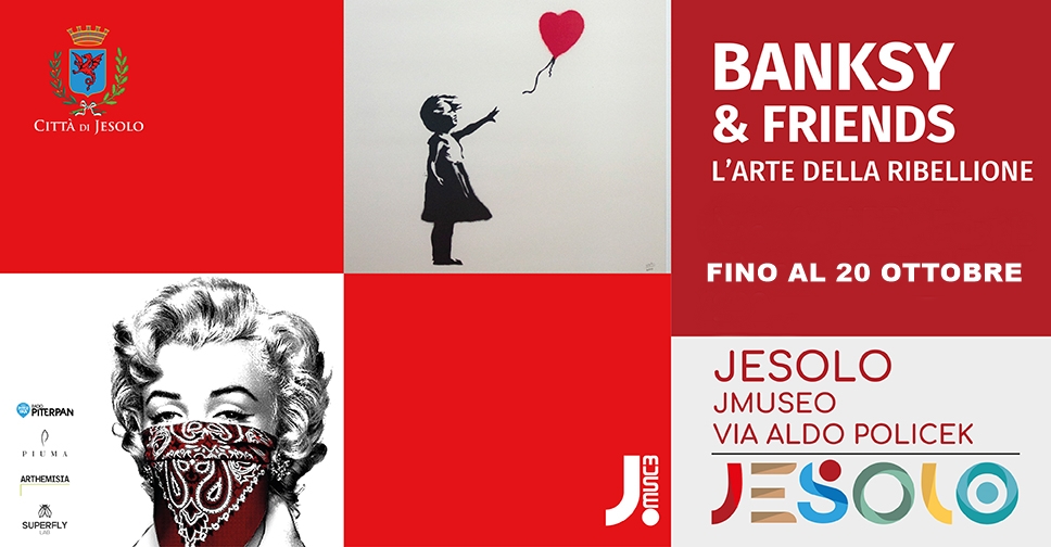 Banksy & Friends - L'arte della ribellione La mostra al Jmuseo di Jesolo fino al 20 ottobre 2024. Immagin e con due opere, la bambina col palloncino a cuore e Merilyn con la bandana a mascherare bocca e naso